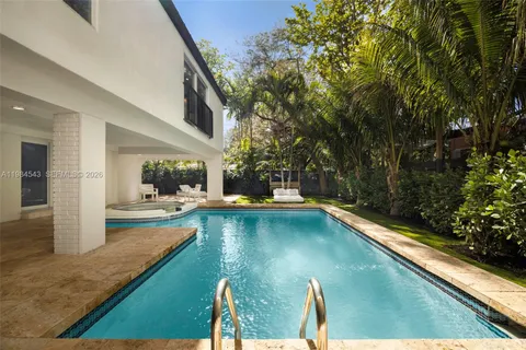 a swimming pool with outdoor seating and yard
