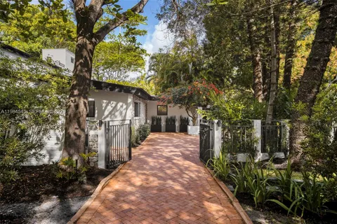 a aerial view of residential house with outdoor space and trees all around