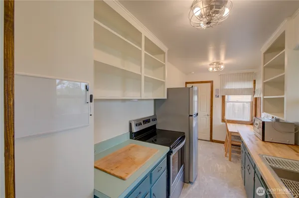 a kitchen with a refrigerator and a stove