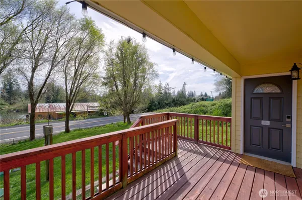 a view of a balcony with wooden floor and fence