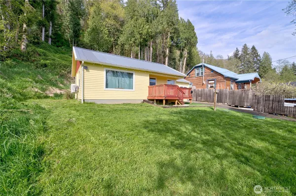 a front view of a house with yard and green space