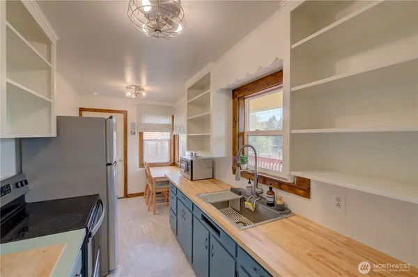 a kitchen with stainless steel appliances a sink stove and refrigerator