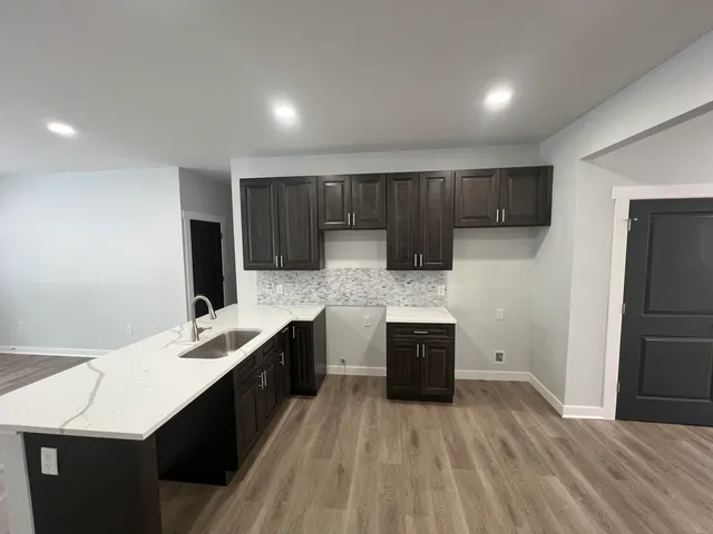 a kitchen with sink cabinets and stainless steel appliances