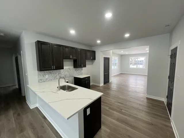 a kitchen with a sink and refrigerator