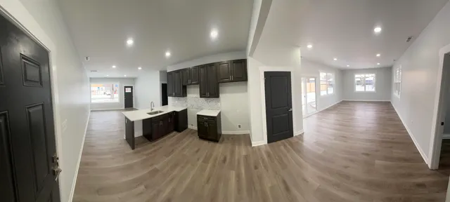 a view of kitchen with cabinets microwave and stove