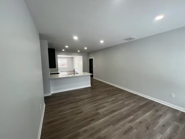 a view of kitchen with refrigerator and window