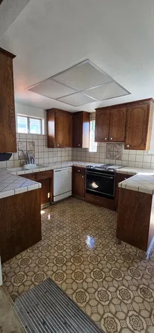 a kitchen with stainless steel appliances kitchen island granite countertop a sink and cabinets