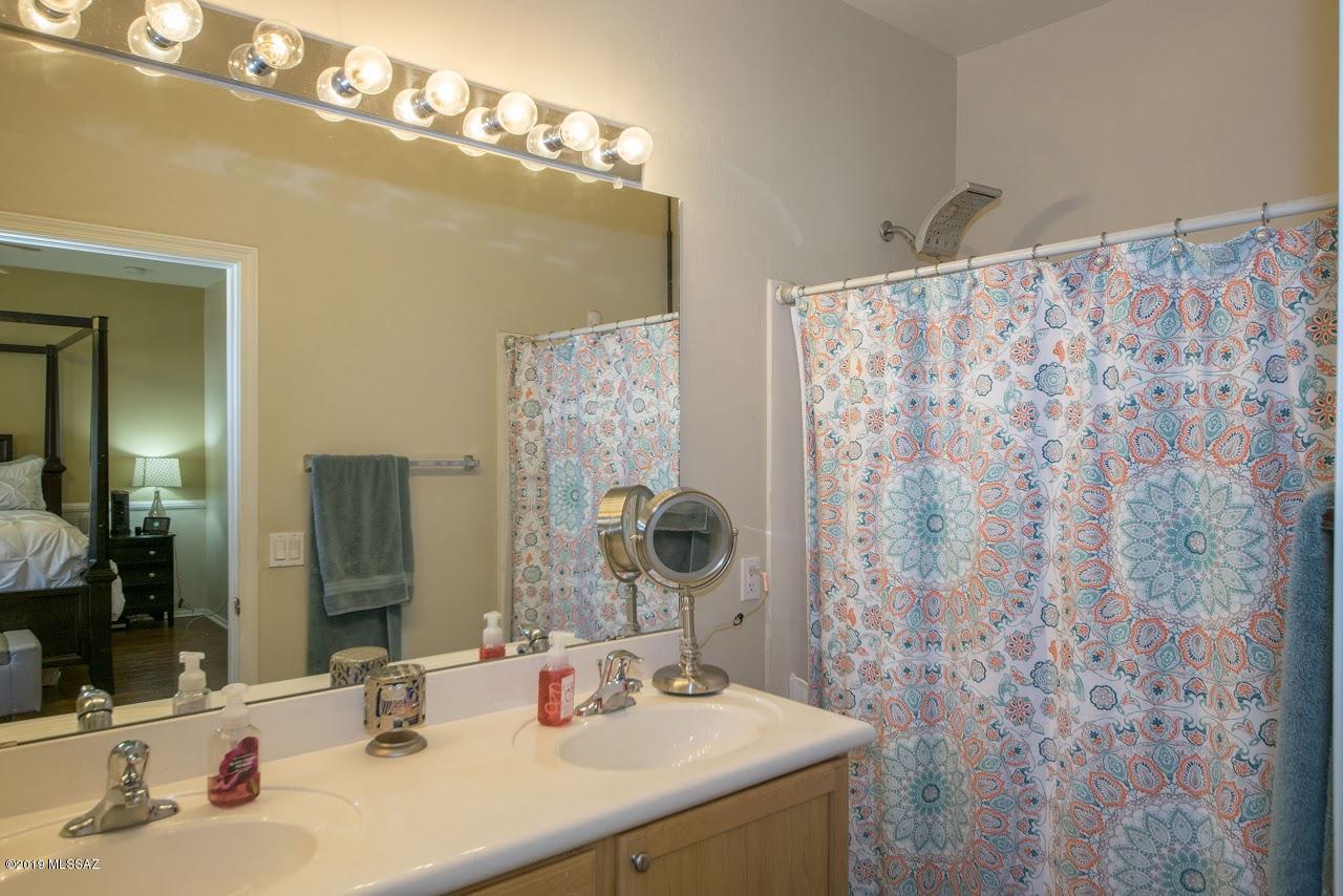 3701 East Northern Dancer Road Tucson, AZ 85739 - Photo 31 of 32 a bathroom with a sink and a mirror