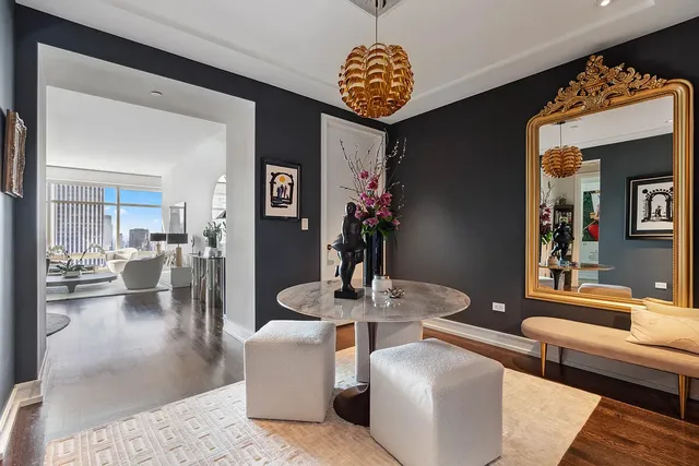 a living room with furniture and a chandelier