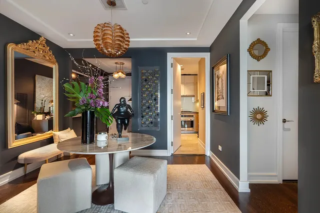a view of a dining room with furniture and a chandelier