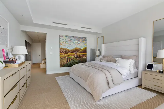 a large white bed in a white room