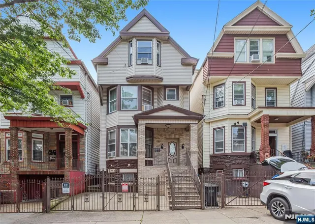 a front view of a residential apartment building with a yard