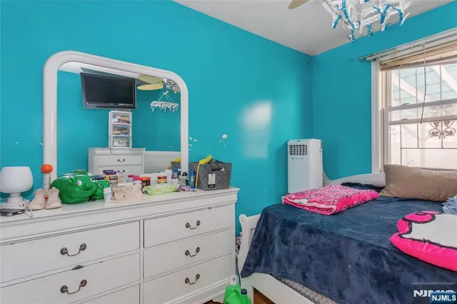 a bedroom with a bed and a dresser