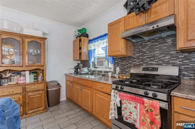 a kitchen with stainless steel appliances a stove a sink dishwasher and cabinets
