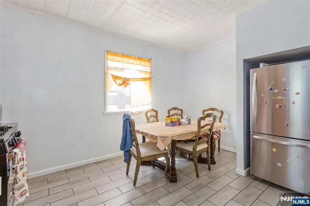 a view of a dining room with furniture and a window