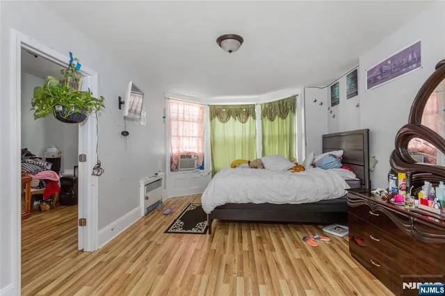 a bed sitting in a bedroom next to a window