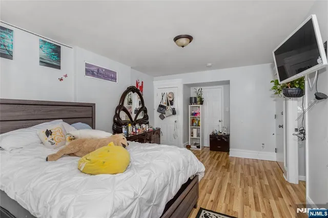 a bed room with a bed and a flat screen tv