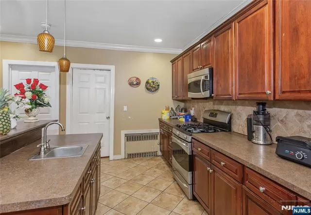a kitchen with stainless steel appliances granite countertop a sink dishwasher stove top oven microwave and cabinets