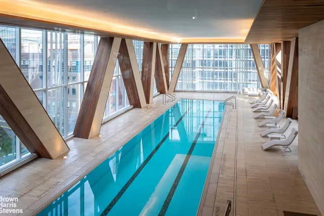 a living room with fireplace furniture and a large window