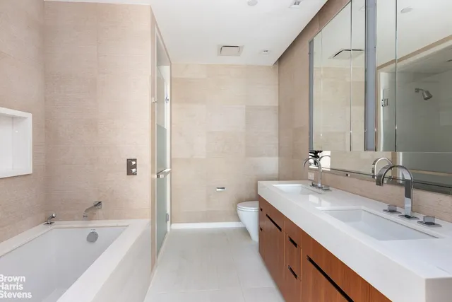 a bedroom with furniture and a large window