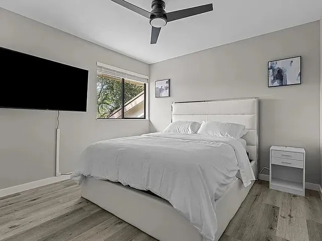 a bedroom with a bed and a flat screen tv