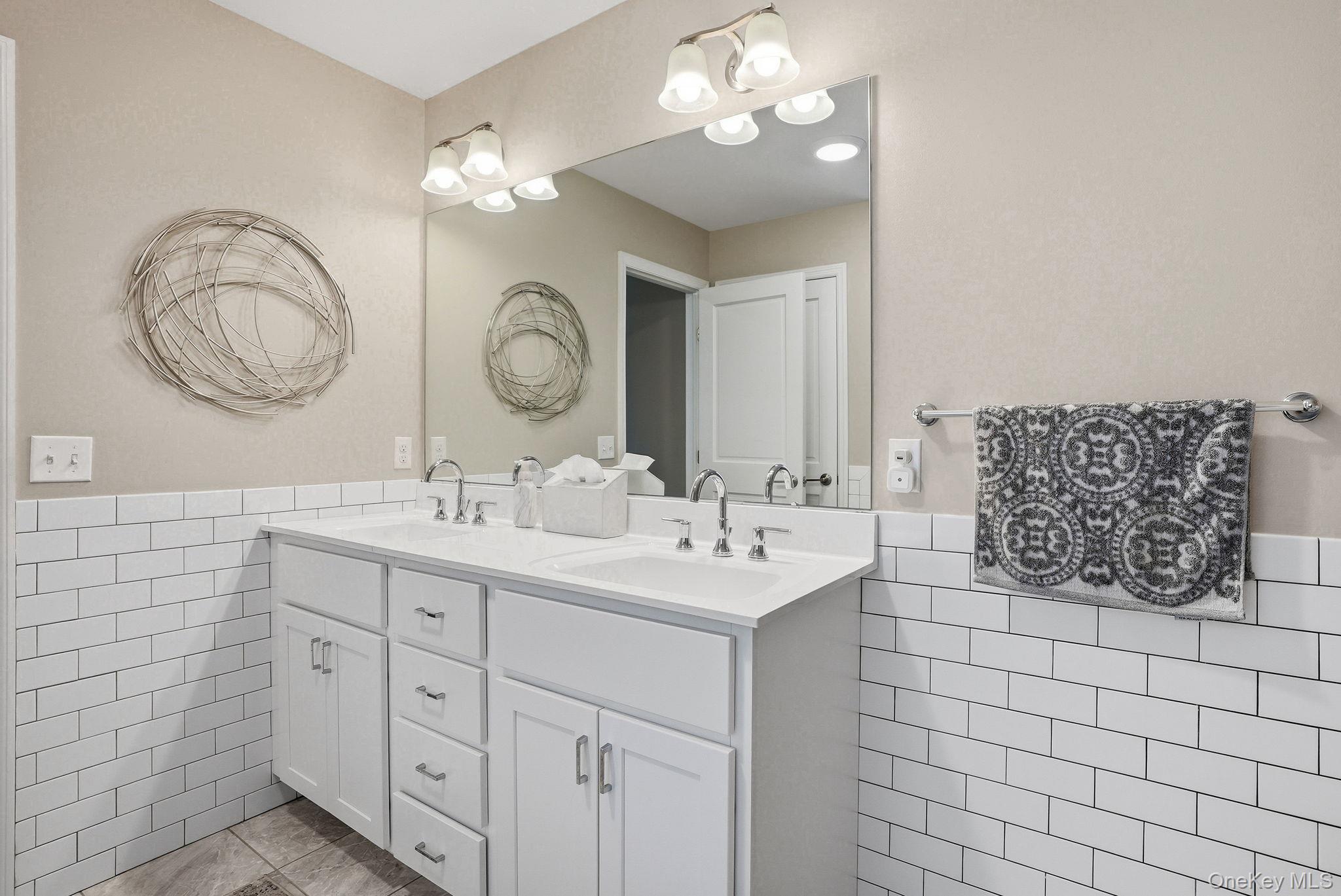 8 Muscoot River Road Granite Springs, NY 10527 - Photo 21 of 40 Primary bathroom featuring double vanity with white cabinetry and chrome hardware, featuring two undermount sinks and a large framed mirror
