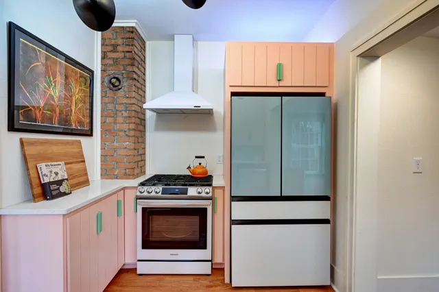 a kitchen with stainless steel appliances granite countertop a refrigerator and a stove top oven