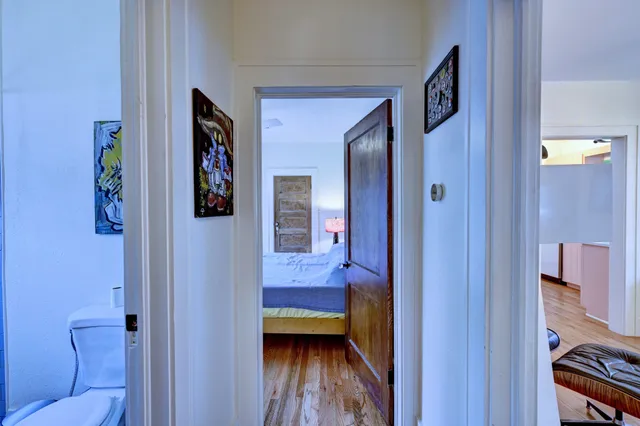 a bedroom with a bed and a large window