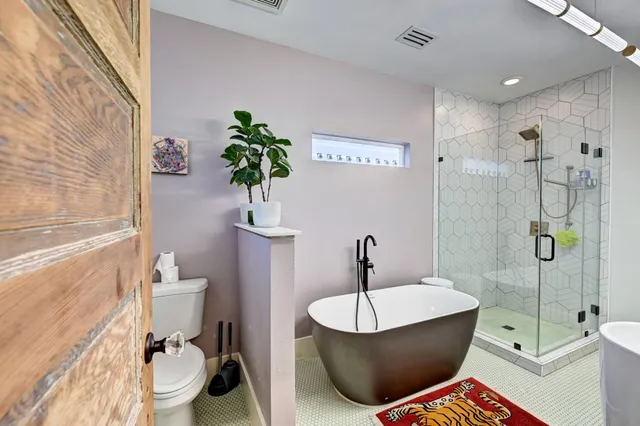 a bathroom with a shower a toilet and a shower