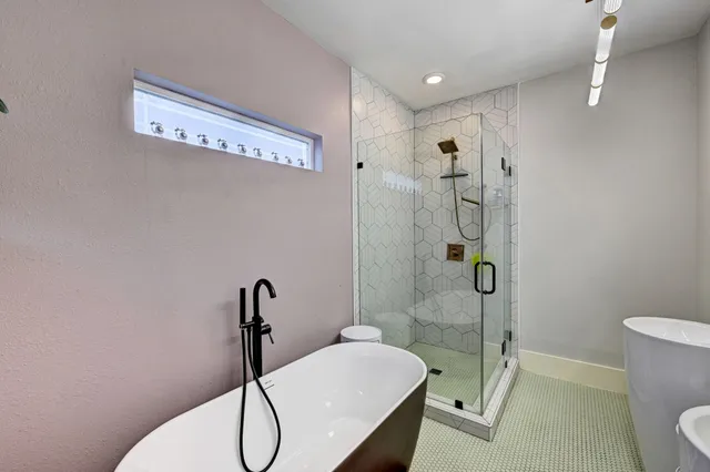 a bathroom with a sink mirror bathtub and toilet