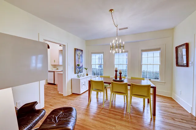 a kitchen with wooden floors and wooden cabinets