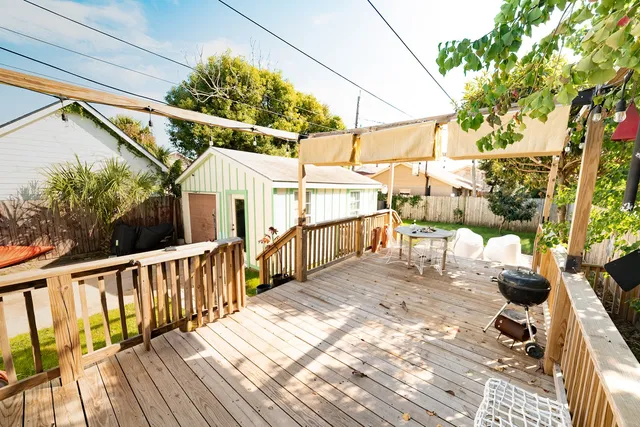 a living room with furniture flat screen tv and a large window