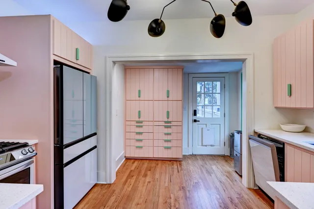 a kitchen with wooden floors and wooden cabinets