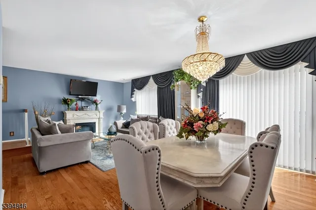 a view of a dining room with furniture wooden floor and a chandelier