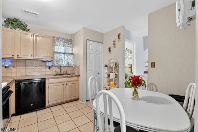 a kitchen with stainless steel appliances granite countertop a stove a sink dishwasher and a refrigerator
