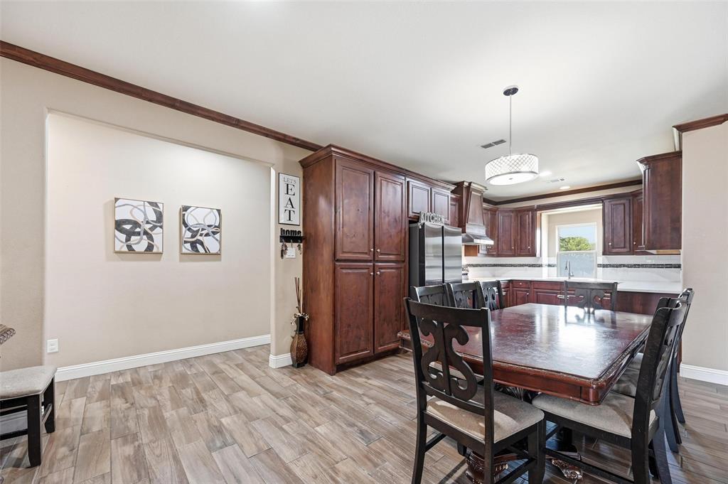 559 Northstar Road Fate, TX 75189 - Photo 13 of 32 a view of a dining room with furniture window and wooden floor