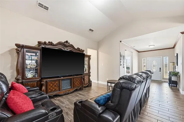 a living room with furniture and a flat screen tv