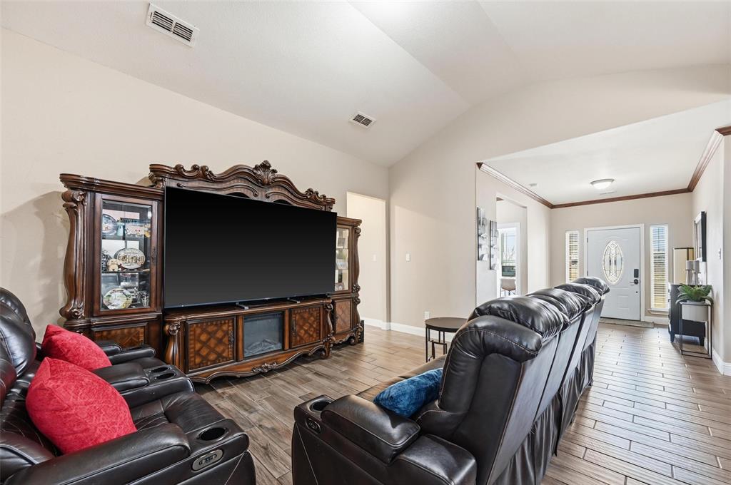 559 Northstar Road Fate, TX 75189 - Photo 14 of 32 a living room with furniture and a flat screen tv