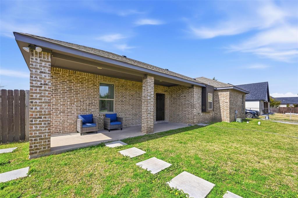 559 Northstar Road Fate, TX 75189 - Photo 17 of 32 a backyard of a house with yard table and chairs
