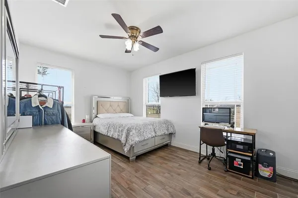 a bedroom with furniture and a flat screen tv