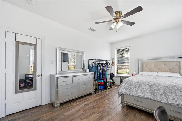 a bedroom with a bed and a large window