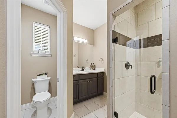 a bathroom with a toilet sink and shower