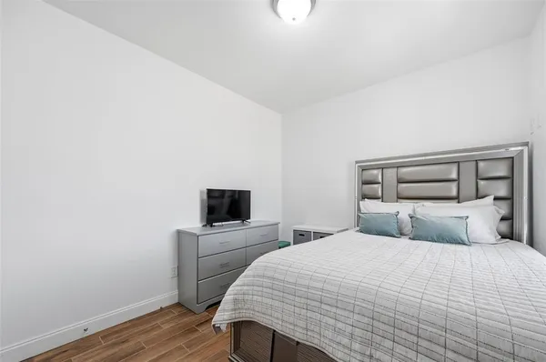 a bedroom with a bed and a tv