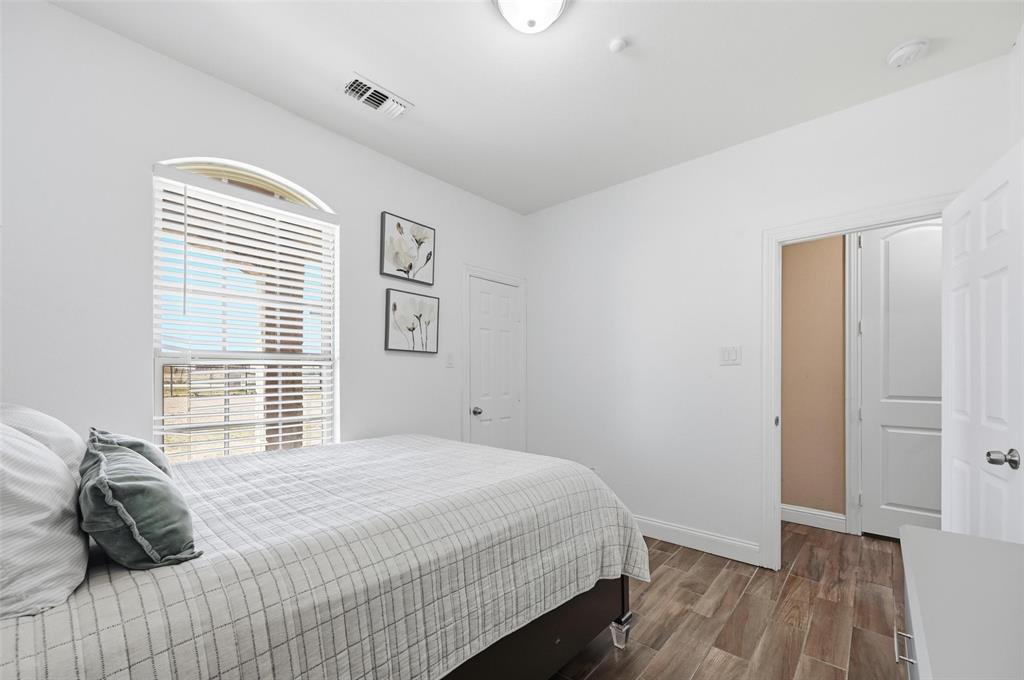 559 Northstar Road Fate, TX 75189 - Photo 27 of 32 a bedroom with a bed and a window
