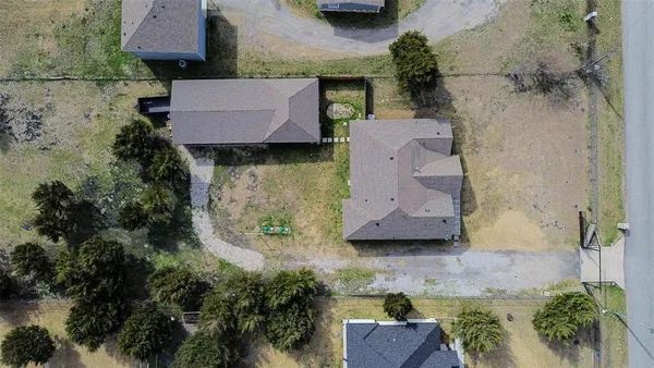 an aerial view of a house with garden space and a car park