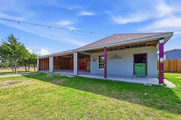 a front view of house with yard and outdoor seating