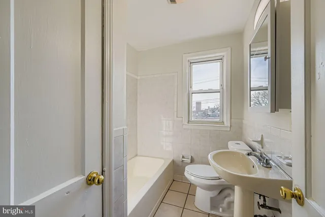 a bathroom with a sink toilet and tub