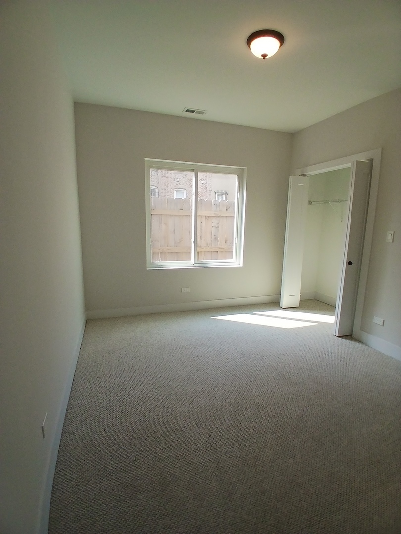 4608 South Indiana Avenue, Unit 1 Chicago, IL 60653 - Photo 13 of 24 an empty room with a empty space and windows