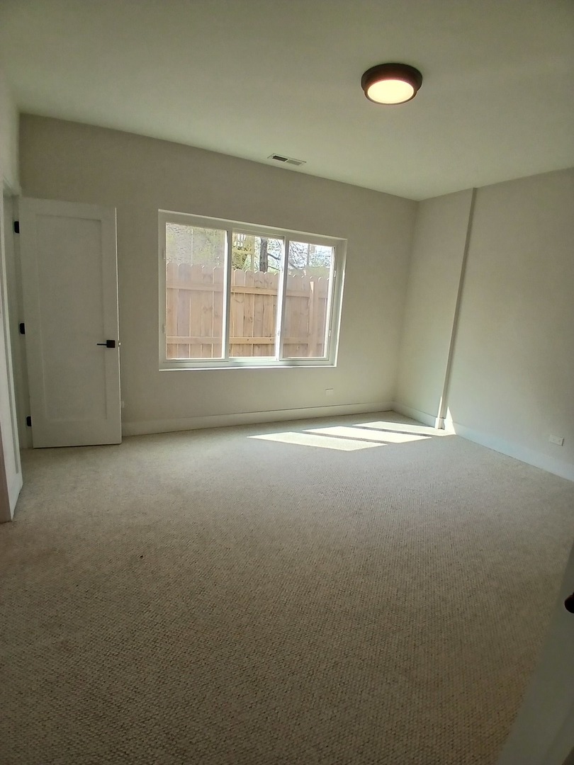 4608 South Indiana Avenue, Unit 1 Chicago, IL 60653 - Photo 18 of 24 an empty room with a empty space and windows