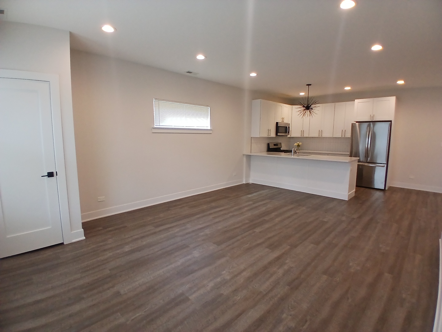 4608 South Indiana Avenue, Unit 1 Chicago, IL 60653 - Photo 4 of 24 a view of kitchen with wooden floor and electronic appliances